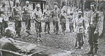  ( Combat Survival Training 1962. ) During the Combat Survival Courses held at the Jungle Warfare School in September and October, HQ Int Corps (FE) was responsible for providing a Resistance to Interrogation phase.  Twenty Intelligence Corps Officers and SNCOs, from throughout the Far East, were brought together as interrogators.  L-R : Maj Norman Dunkley, ??, Sgt Graham, Ivan Spanholz, Capt Alan Whipp, ??, Sgt Croft. Sgt Ross, ??, ??, POW. 